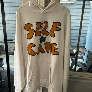 White Hoodie with 'Self Care' Graphic